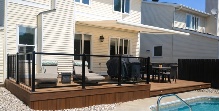 Beautiful Two-Tier Trex Composite Deck in Orleans with Aluminum Glass Rails Overlooking a Pool